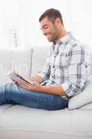 Relaxing man on a sofa with a book