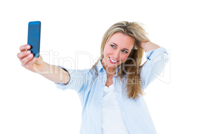 Pretty blonde taking a selfie with smartphone