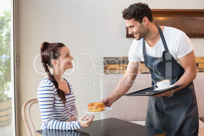 Pretty brunette being served a bagel