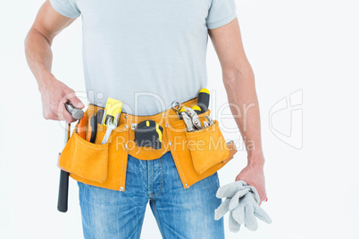 Technician holding gloves and hammer