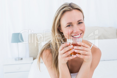 Pretty blonde holding mug of hot beverage