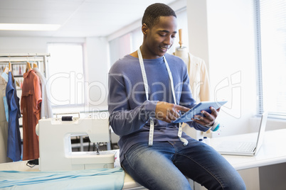 Smiling university student using tablet pc