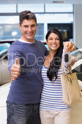 Smiling couple holding their new car key