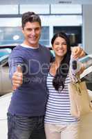 Smiling couple holding their new car key