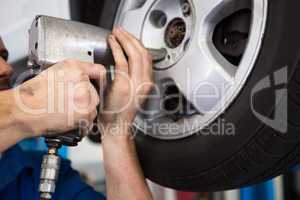 Mechanic adjusting the tire wheel