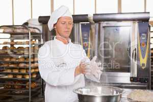 Baker clapping flour from his hands