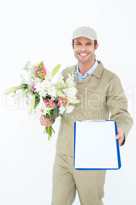 Delivery man with bouquet giving clipboard for signature