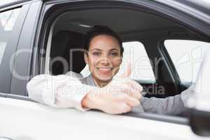 Smiling businesswoman giving thumbs up