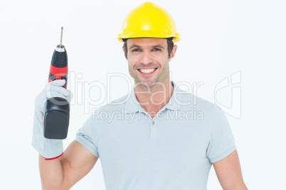 Confident carpenter holding cordless drill machine