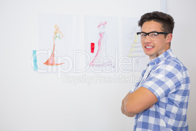 Smiling college student posing with arms crossed