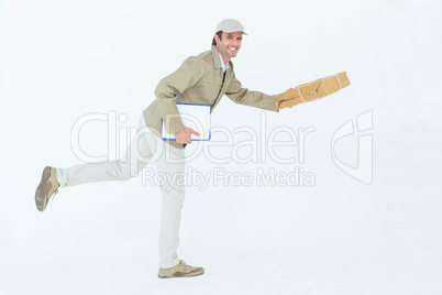 Happy delivery man running while holding parcel