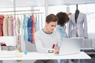 Students working with laptop and model