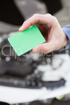 Close up of man holding card