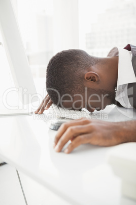 Exhausted businessman napping on keyboard