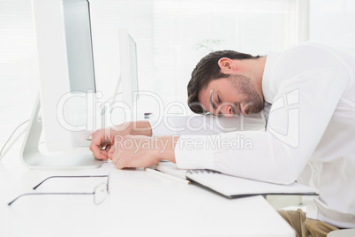 Tired businessman sleeping on keyboard