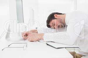 Tired businessman sleeping on keyboard