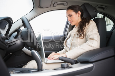 Businesswoman working in the drivers seat