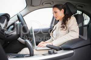 Businesswoman working in the drivers seat