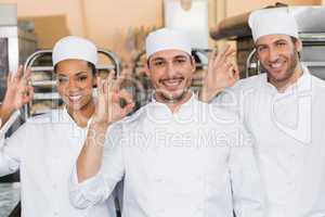 Team of bakers smiling at camera