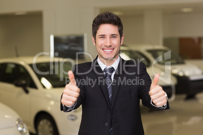 Smiling businessman giving thumbs up