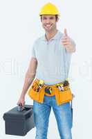 Handyman showing thumbs up while holding tool box