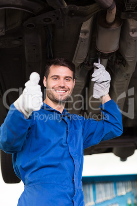 Mechanic examining under the car