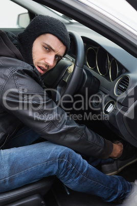 Thief breaking into a car