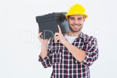 Happy male repairman carrying toolbox on shoulder