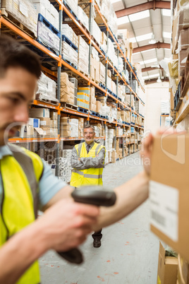 Warehouse worker scanning barcode on box