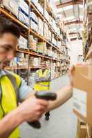 Warehouse worker scanning barcode on box