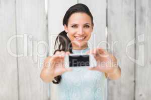 Stylish brunette taking a selfie