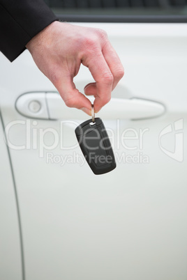 Close up of businessman holding car key