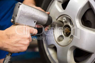 Mechanic adjusting the tire wheel