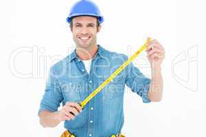 Male architect holding tape measure