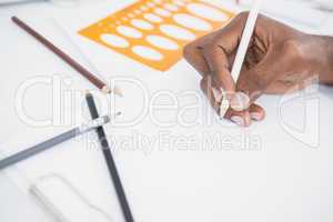 Hand of businessman drawing on paper with pencil