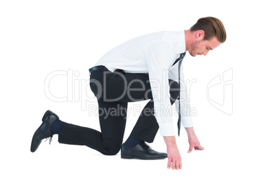 Businessman with hands and one knee on the floor