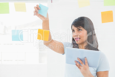 Businesswoman holding digital tablet and sticky notes Businesswoman holding digital tablet and sticky notes