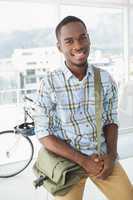 Cheerful businessman posing with shoulder bag