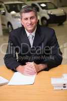 Cheerful businessman working at his desk