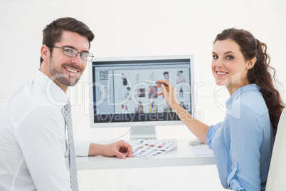 Portrait of smiling teamwork using computer