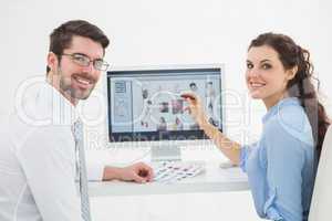 Portrait of smiling teamwork using computer