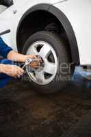 Mechanic adjusting the tire wheel