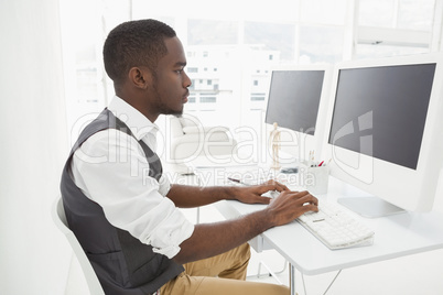 Classy businessman concentrating and using computer