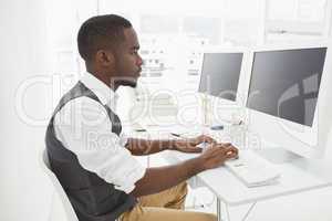 Classy businessman concentrating and using computer