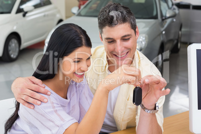 Smiling couple holding their new car key