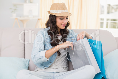 Pretty brunette looking at shopping bags