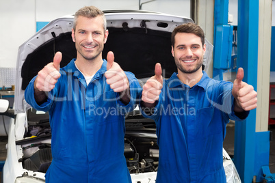 Team of mechanics smiling at camera