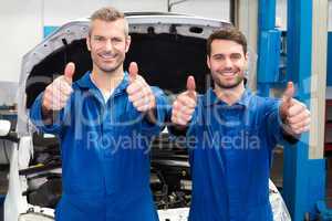 Team of mechanics smiling at camera