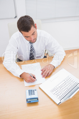 Businessman writing on a paper