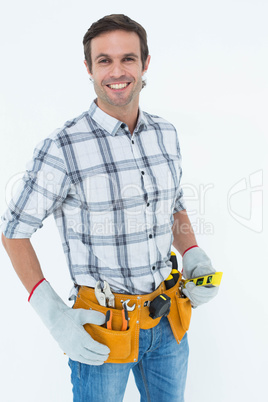 Confident technician holding spirit level